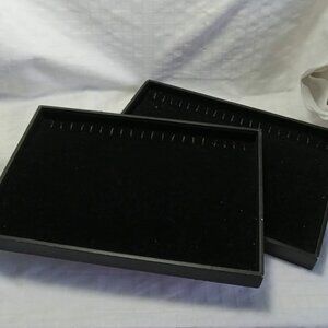 Two black velvet displays for necklaces